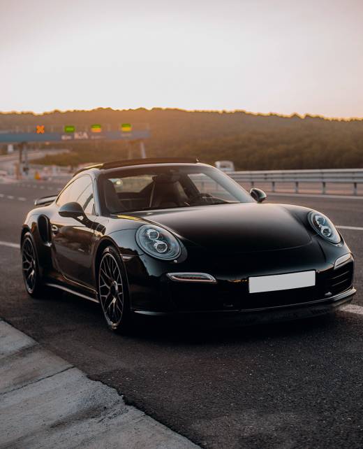 Black Mini coupe Porsche on the road