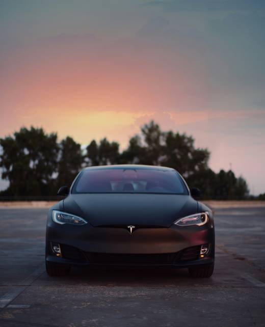 A black Tesla in sunset